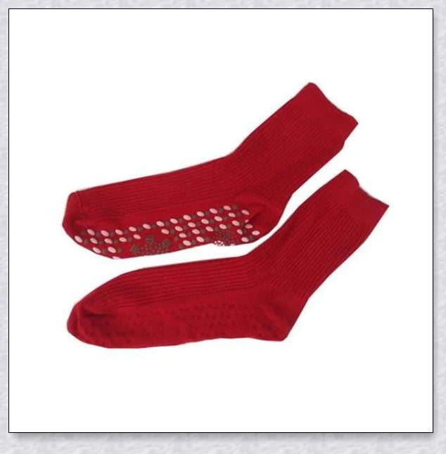 Pair of self-heating massage socks with detailed view of the acupressure-inspired soles