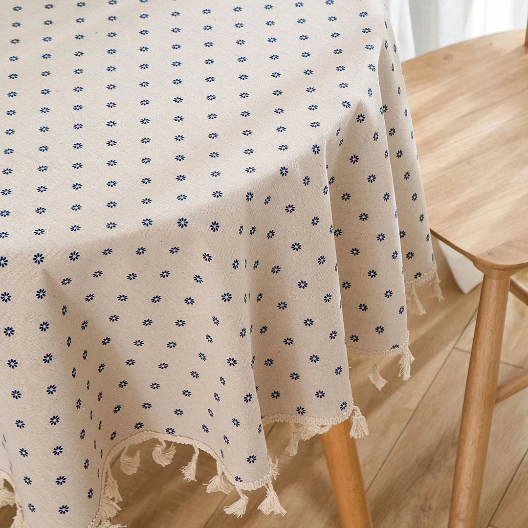 A round cotton linen tablecloth with a floral print and tassels, perfect for enhancing your dining experience.