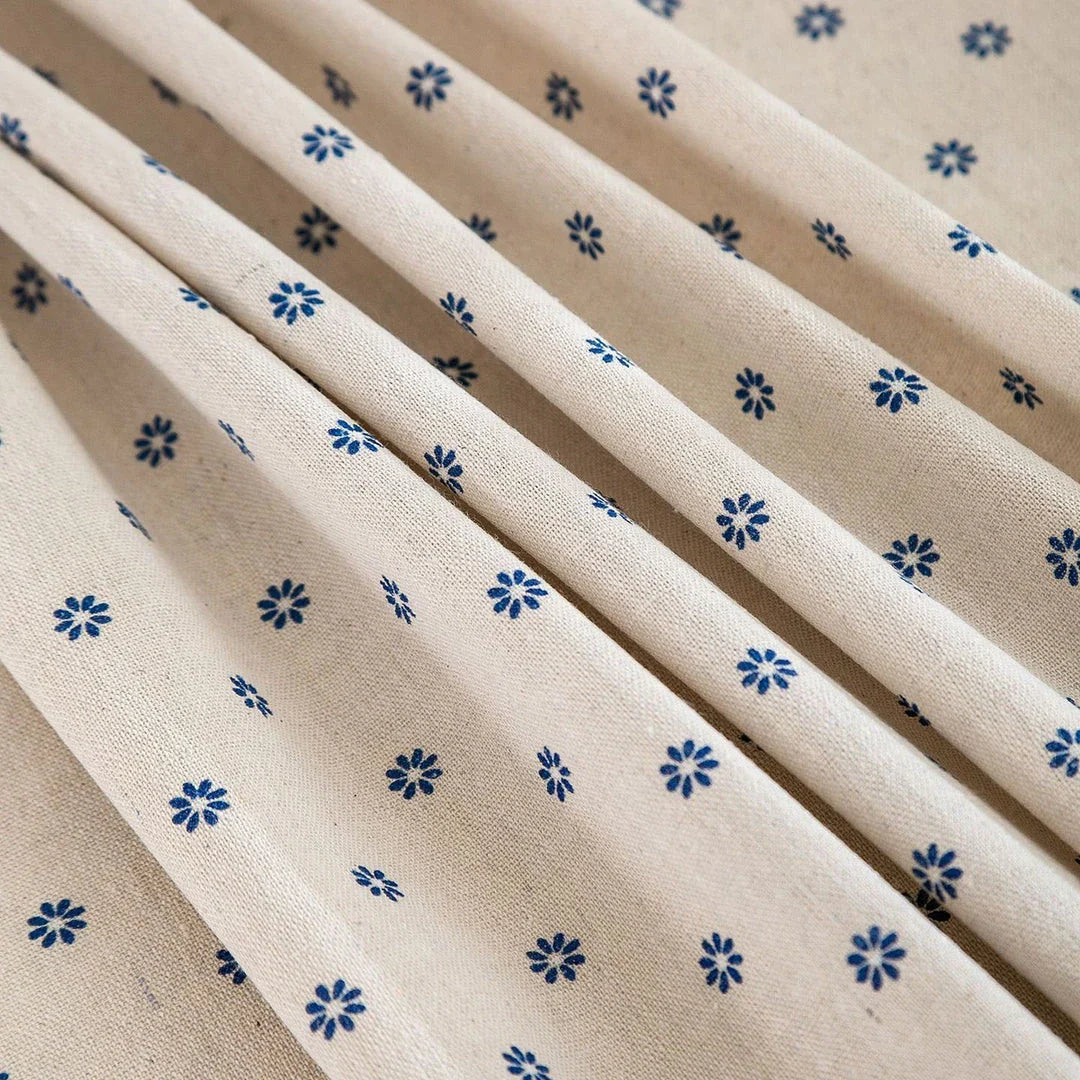 A round cotton linen tablecloth with a floral print and tassels, perfect for enhancing your dining experience.