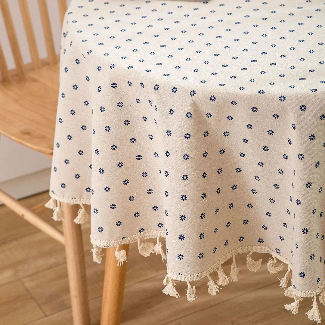 A round cotton linen tablecloth with a floral print and tassels, perfect for enhancing your dining experience.
