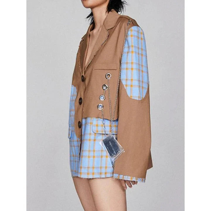 A chic women's winter blazer with a checkered pattern and chain accent, perfect for the modern British fashion enthusiast.