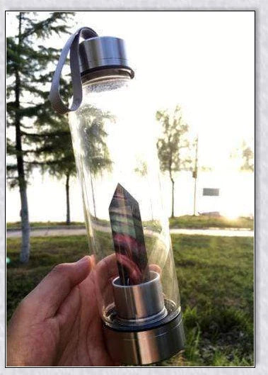 A handcrafted glass water bottle infused with natural crystals, offering a unique and sustainable hydration experience.