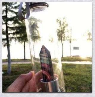 A handcrafted glass water bottle infused with natural crystals, offering a unique and sustainable hydration experience.