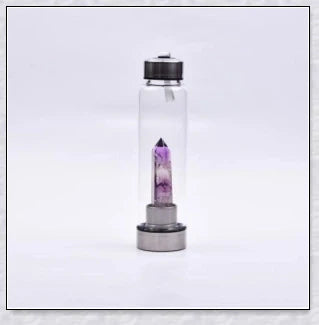 A handcrafted glass water bottle infused with natural crystals, offering a unique and sustainable hydration experience.