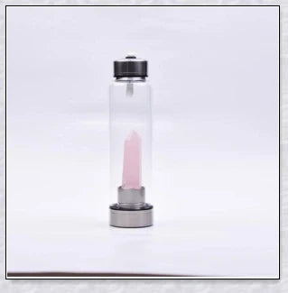 A handcrafted glass water bottle infused with natural crystals, offering a unique and sustainable hydration experience.