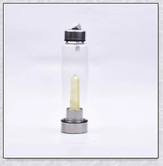 A handcrafted glass water bottle infused with natural crystals, offering a unique and sustainable hydration experience.