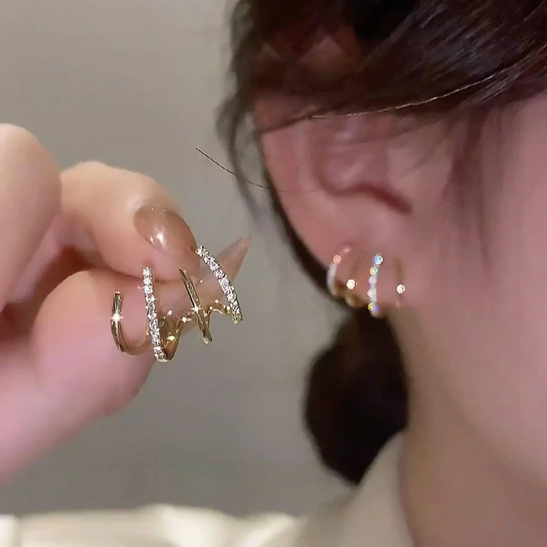 Elegant zircon four-claw stud earrings in a timeless gold colour, perfect for adding a touch of sophisticated style to any outfit.