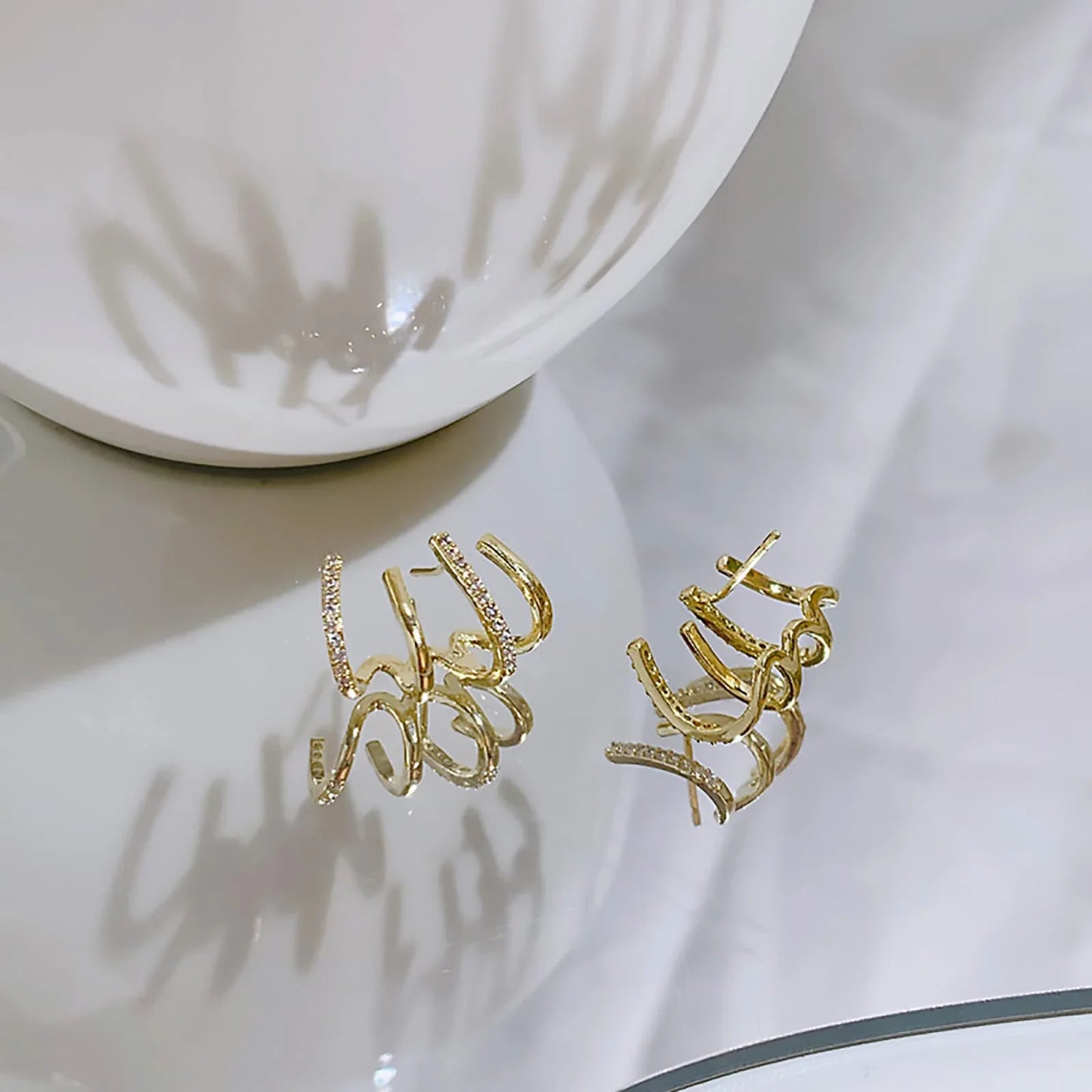 Elegant zircon four-claw stud earrings in a timeless gold colour, perfect for adding a touch of sophisticated style to any outfit.