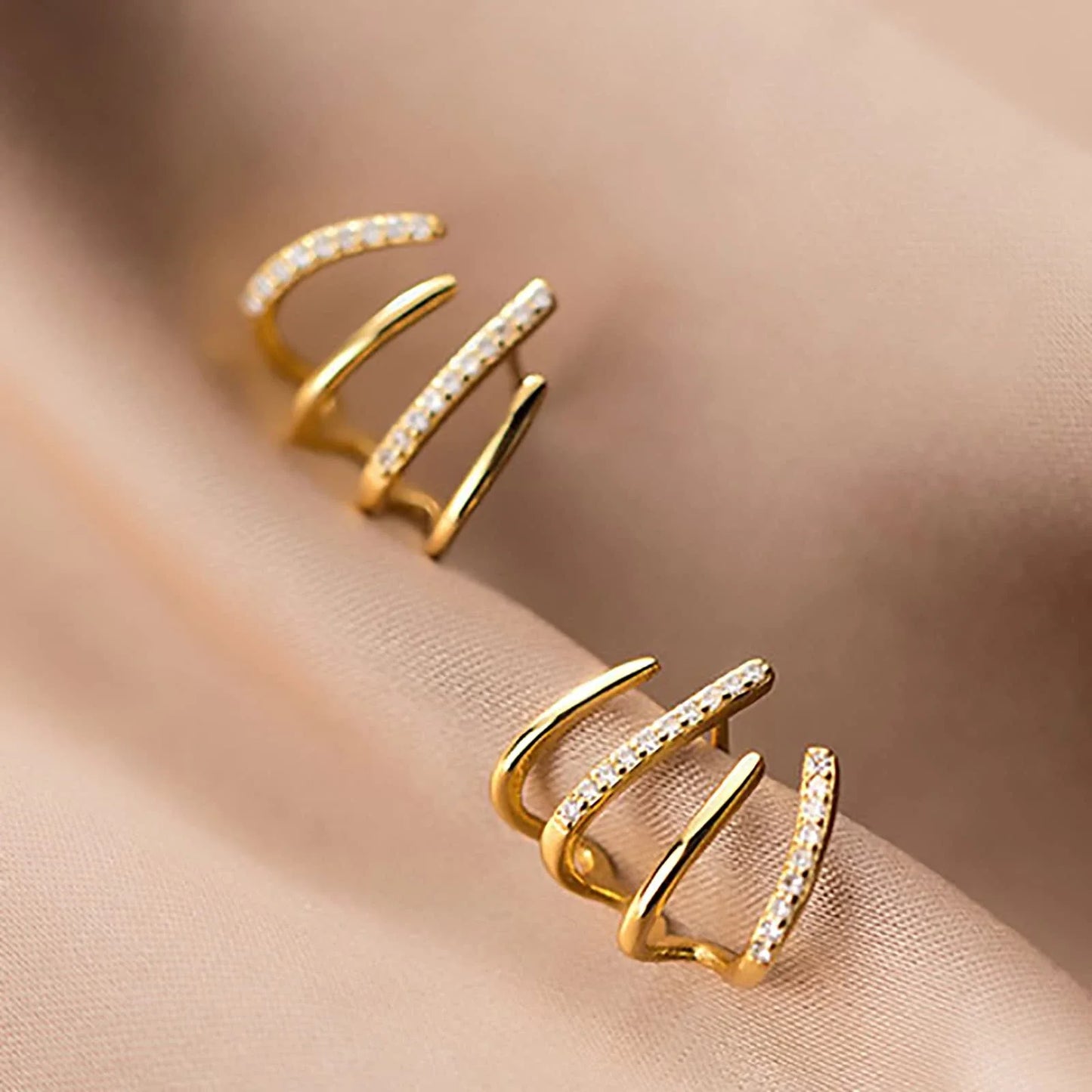 Elegant zircon four-claw stud earrings in a timeless gold colour, perfect for adding a touch of sophisticated style to any outfit.