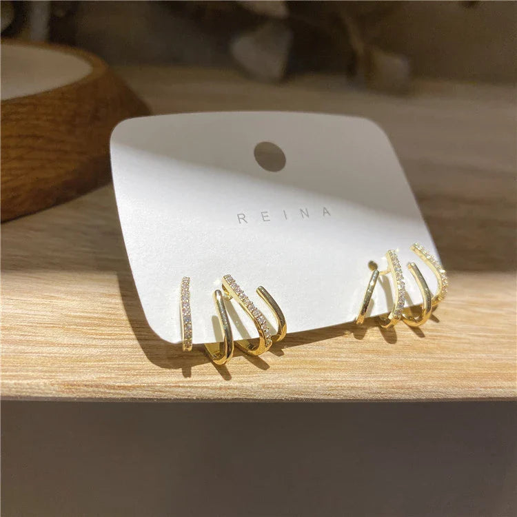 Elegant zircon four-claw stud earrings in a timeless gold colour, perfect for adding a touch of sophisticated style to any outfit.