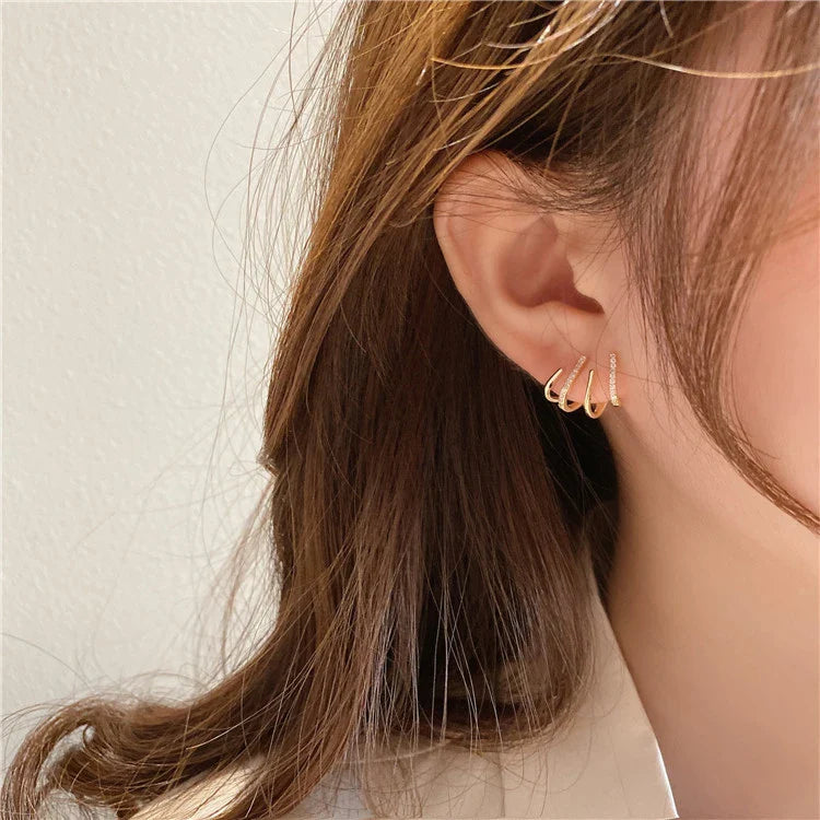 Elegant zircon four-claw stud earrings in a timeless gold colour, perfect for adding a touch of sophisticated style to any outfit.