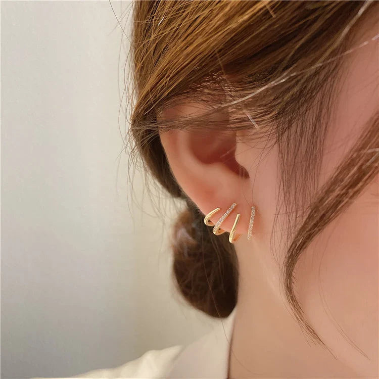 Elegant zircon four-claw stud earrings in a timeless gold colour, perfect for adding a touch of sophisticated style to any outfit.