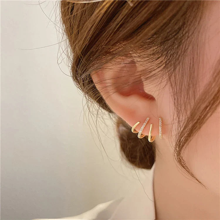 Elegant zircon four-claw stud earrings in a timeless gold colour, perfect for adding a touch of sophisticated style to any outfit.
