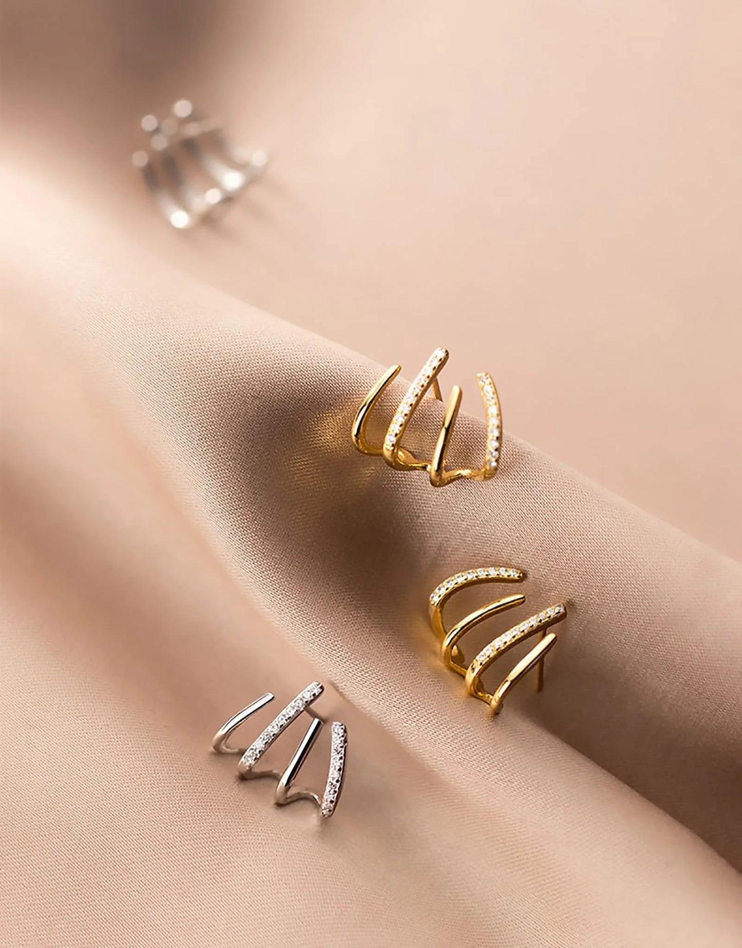 Elegant zircon four-claw stud earrings in a timeless gold colour, perfect for adding a touch of sophisticated style to any outfit.