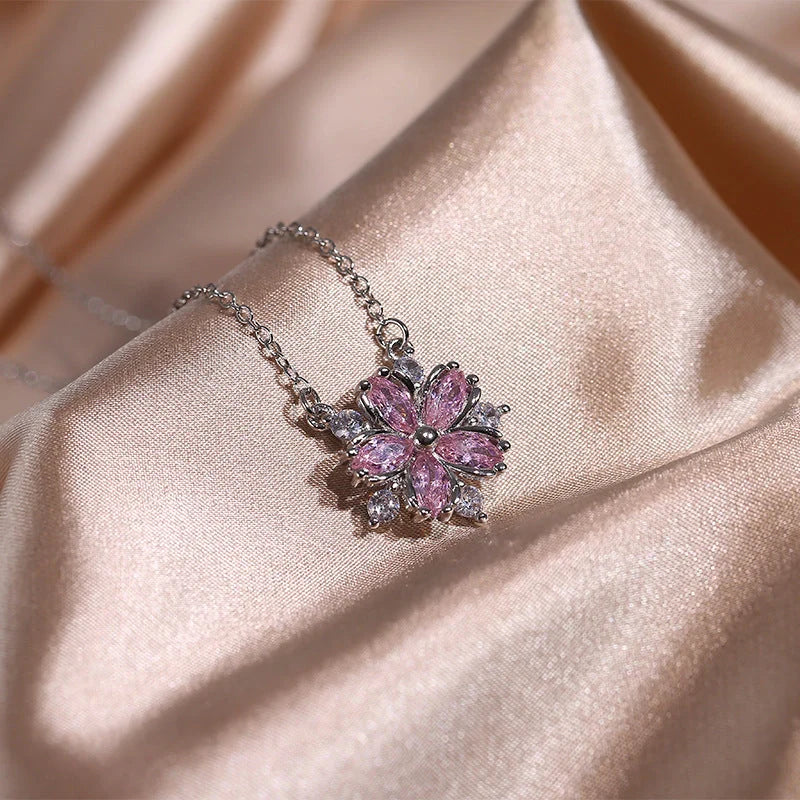Dazzling cubic zirconia jewellery set with double-layered flower design, including ring, necklace, and earrings in pink and white diamond colours