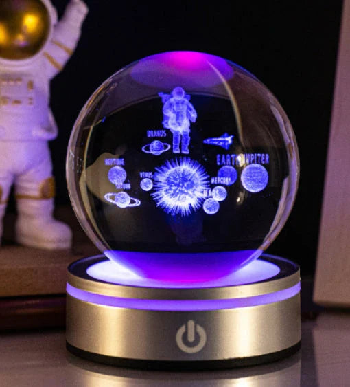 Luminous crystal ball with various celestial-inspired designs, including the Milky Way, Solar System, and Constellation.
