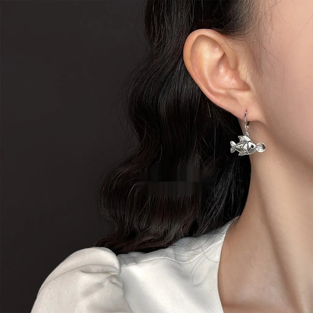 A pair of copper bubble fish earrings with electroplating, showing animal design in a sweet cool style.