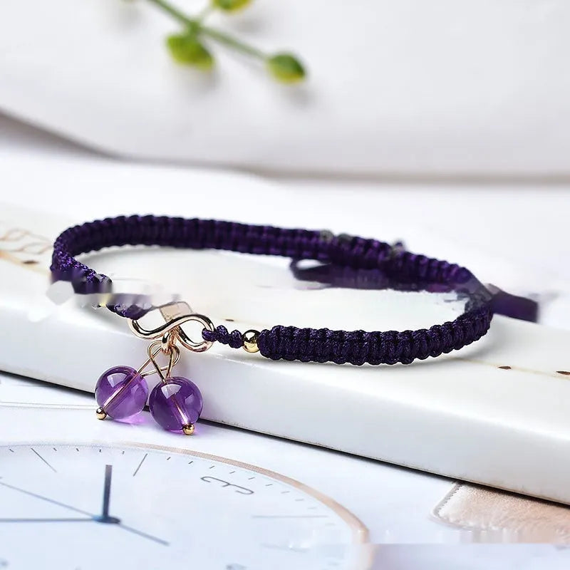 Women's adjustable bracelet with natural strawberry quartz cherry-shaped crystal charms on a chain.