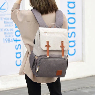 Stylish and functional diaper backpack with large capacity, stroller hooks, and USB charging port for modern parents