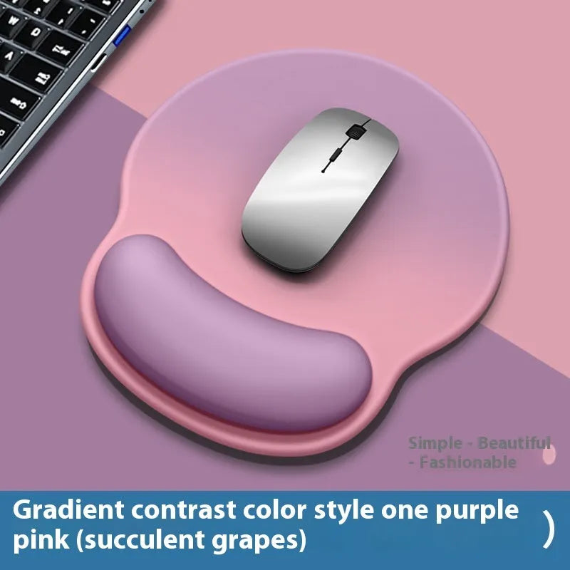 Silicone mouse mat with integrated wrist rest in a gradient blue black colour on a desk.