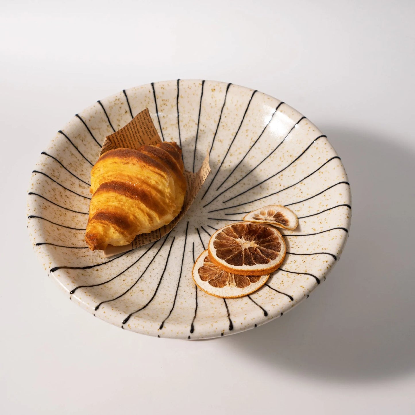 Black and white striped synthetic resin fruit plate with retro fruit motifs, 20cm diameter