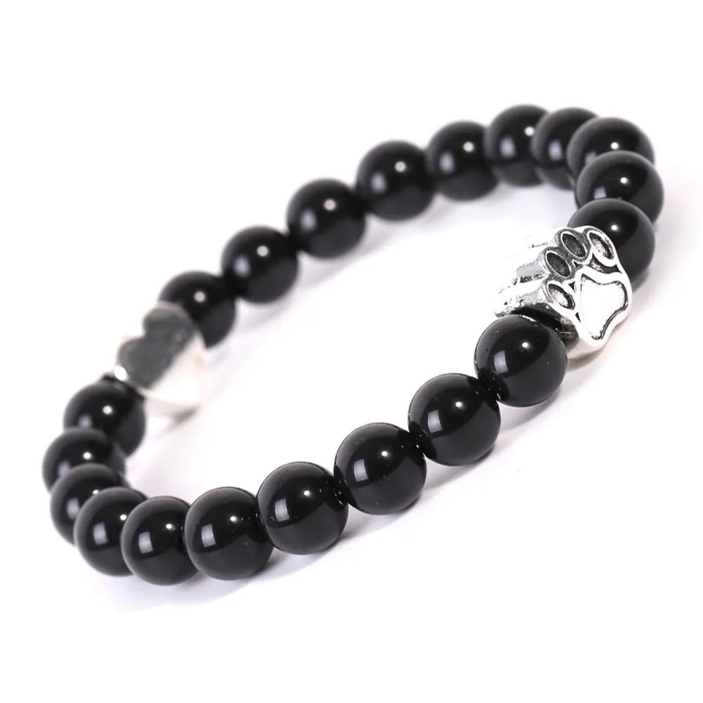 Tiger's eye stone bracelet with dog paw and Indian agate beaded designs on a wrist.