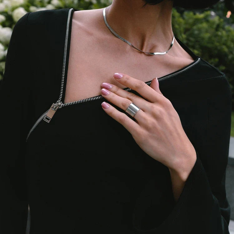 Elegant crossbody dress with zipper detail, high-waisted silhouette, and long sleeves in a solid black colour