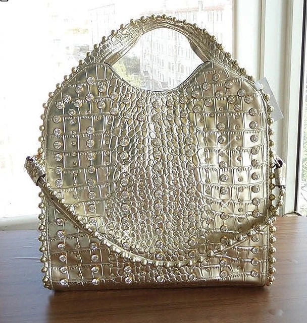 Fashionable diamond-studded messenger bag with shimmering PU leather surface, versatile carrying options, and practical organisational features