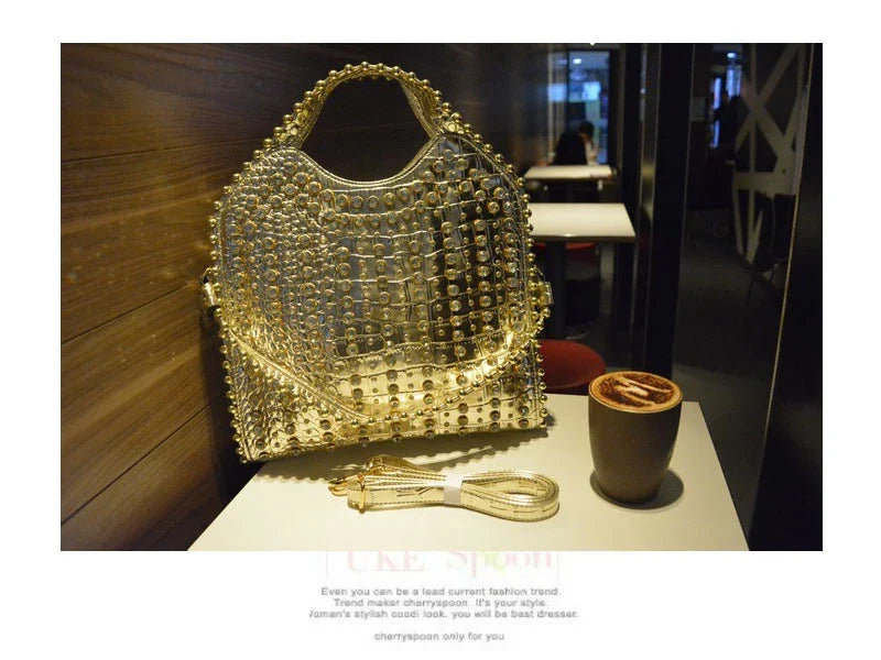 Fashionable diamond-studded messenger bag with shimmering PU leather surface, versatile carrying options, and practical organisational features