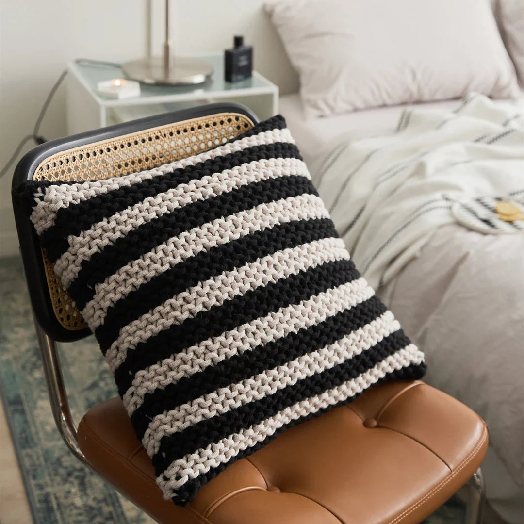A luxurious hand-crocheted throw pillow with a chunky knit design, providing cosy comfort and elegant style for your home decor.