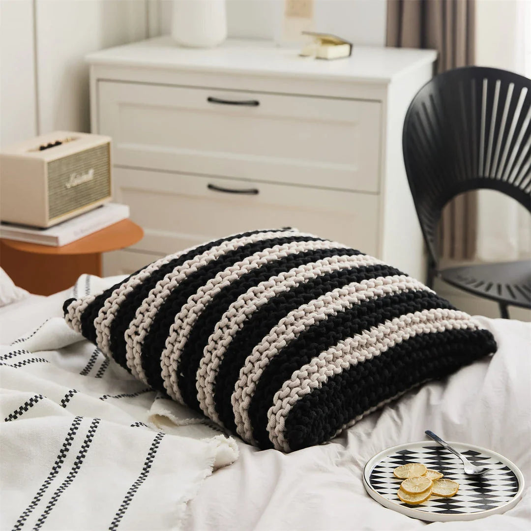A luxurious hand-crocheted throw pillow with a chunky knit design, providing cosy comfort and elegant style for your home decor.