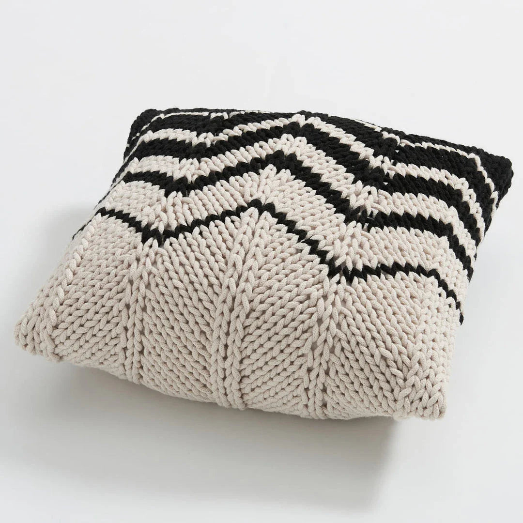 A luxurious hand-crocheted throw pillow with a chunky knit design, providing cosy comfort and elegant style for your home decor.