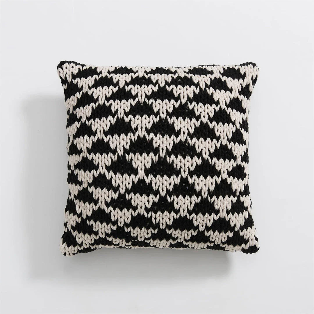 A luxurious hand-crocheted throw pillow with a chunky knit design, providing cosy comfort and elegant style for your home decor.