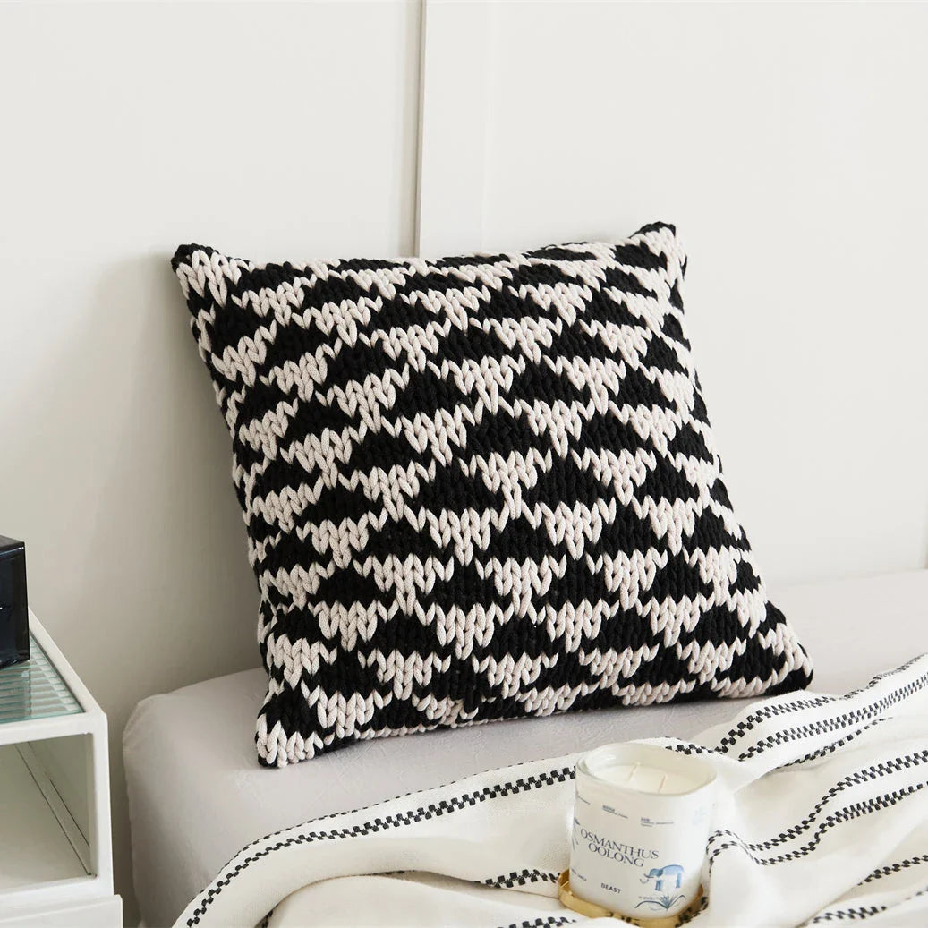 A luxurious hand-crocheted throw pillow with a chunky knit design, providing cosy comfort and elegant style for your home decor.