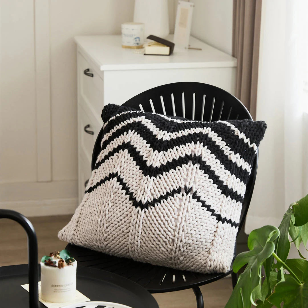 A luxurious hand-crocheted throw pillow with a chunky knit design, providing cosy comfort and elegant style for your home decor.