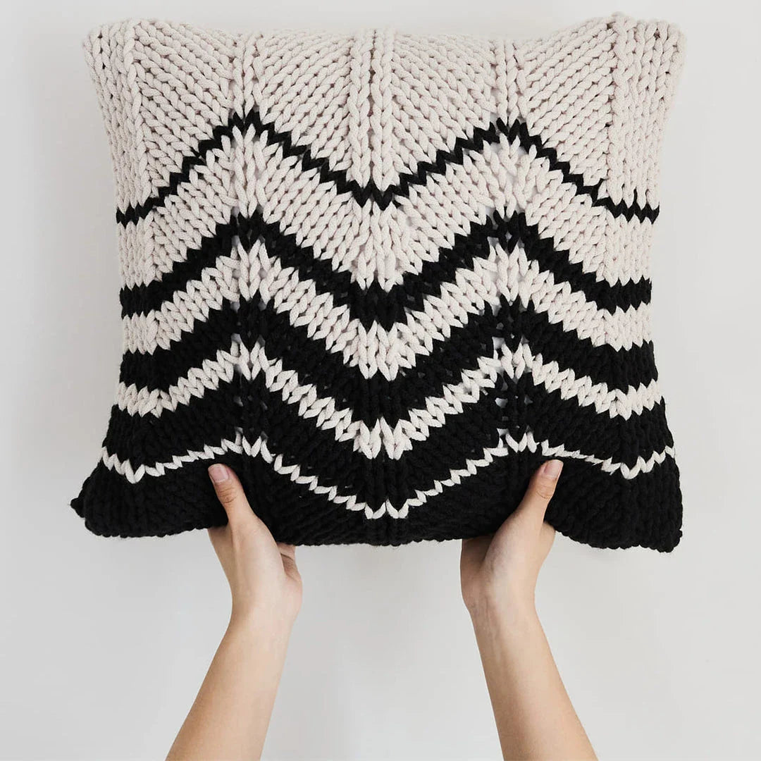 A luxurious hand-crocheted throw pillow with a chunky knit design, providing cosy comfort and elegant style for your home decor.