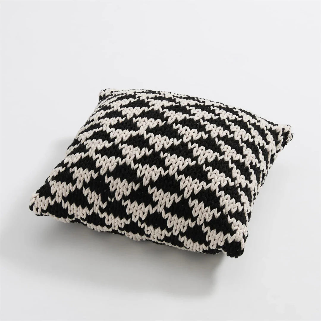 A luxurious hand-crocheted throw pillow with a chunky knit design, providing cosy comfort and elegant style for your home decor.