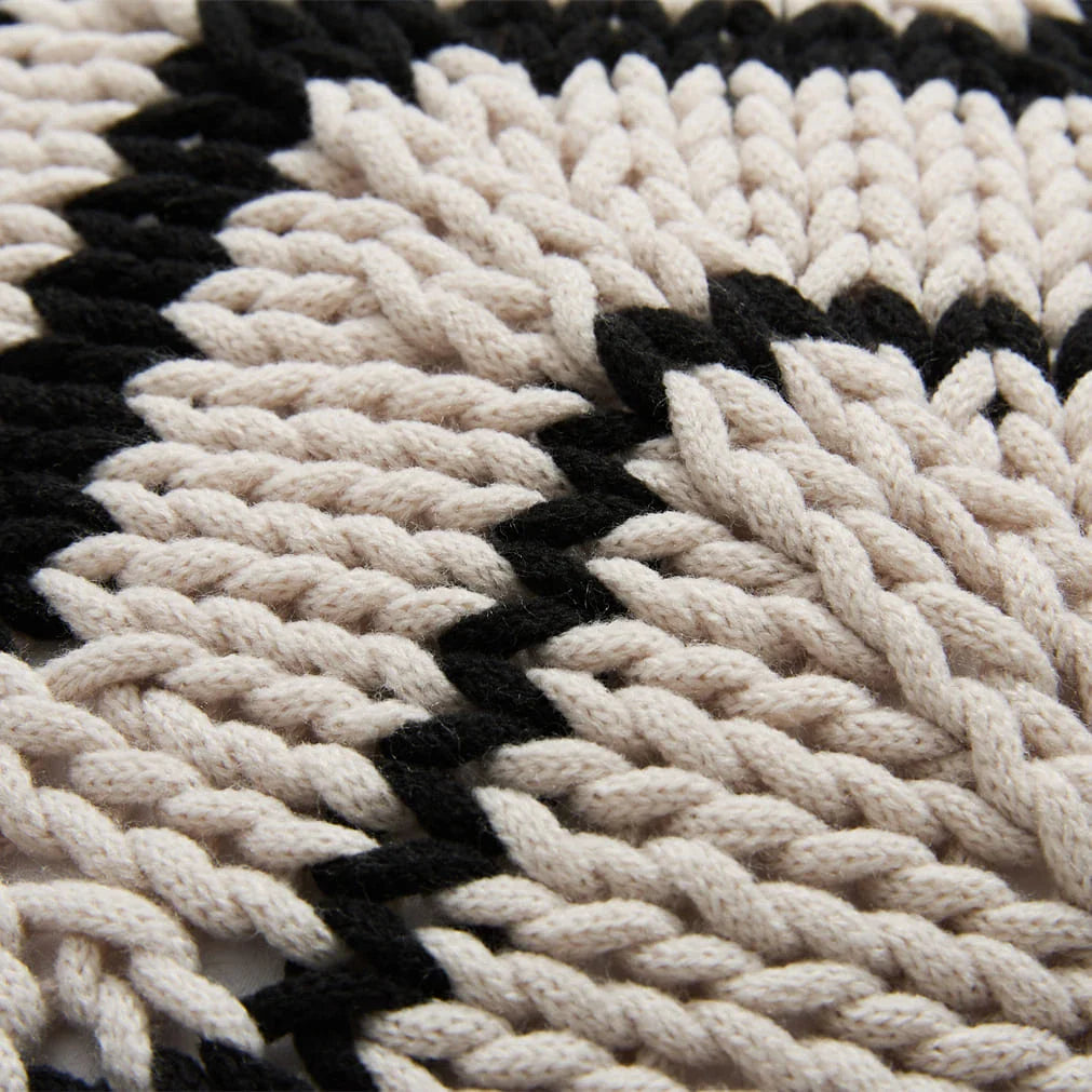 A luxurious hand-crocheted throw pillow with a chunky knit design, providing cosy comfort and elegant style for your home decor.