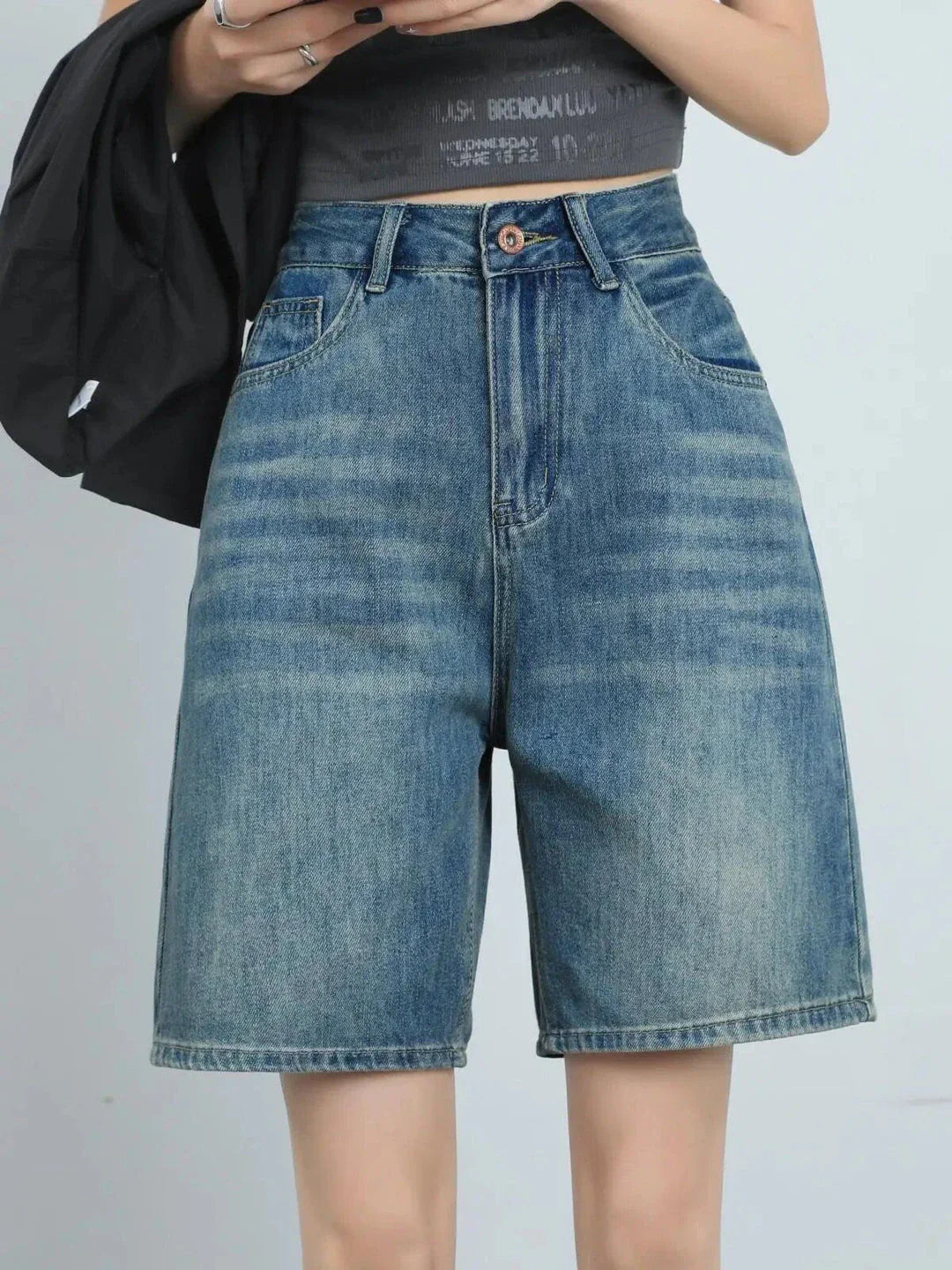 High-waist knee-length denim shorts for women, featuring a flattering silhouette and versatile casual style.