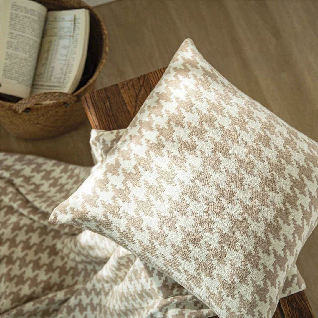 A classic houndstooth-patterned throw pillow cover made from premium 100% cotton with a high thread count for a luxurious feel.
