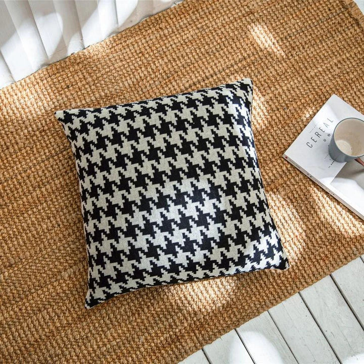 A classic houndstooth-patterned throw pillow cover made from premium 100% cotton with a high thread count for a luxurious feel.