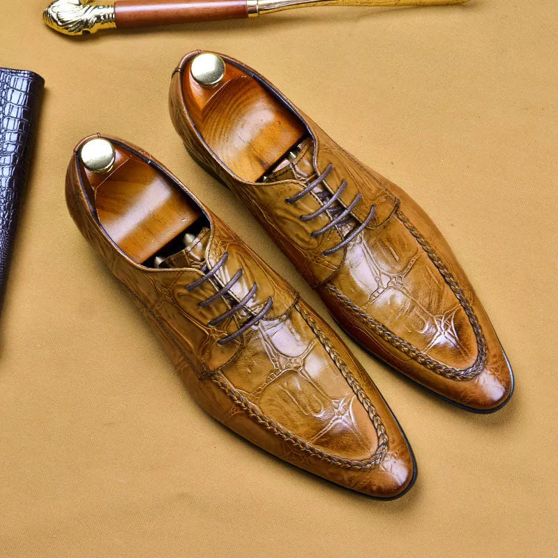 Black men's leather casual shoes with alligator pattern and metal horse bit buckle on a rubber sole.