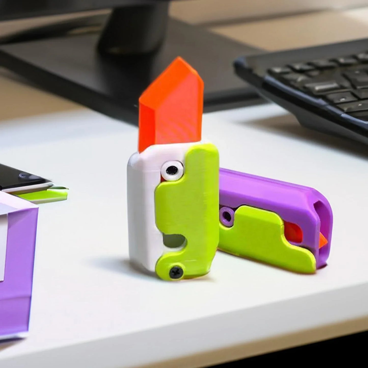 3D printed carrot-shaped fidget knife with gravity-powered hidden blade for stress relief and entertainment