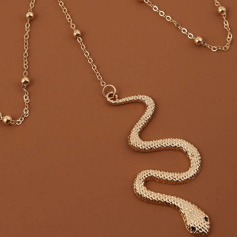 Fashionable gold beaded leg chain with snake pendant for women, featuring a captivating design and adjustable fit for comfortable wear.