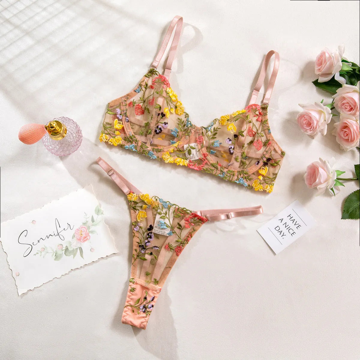 Floral mesh bra and T-back underwear set in skin colour on a mannequin