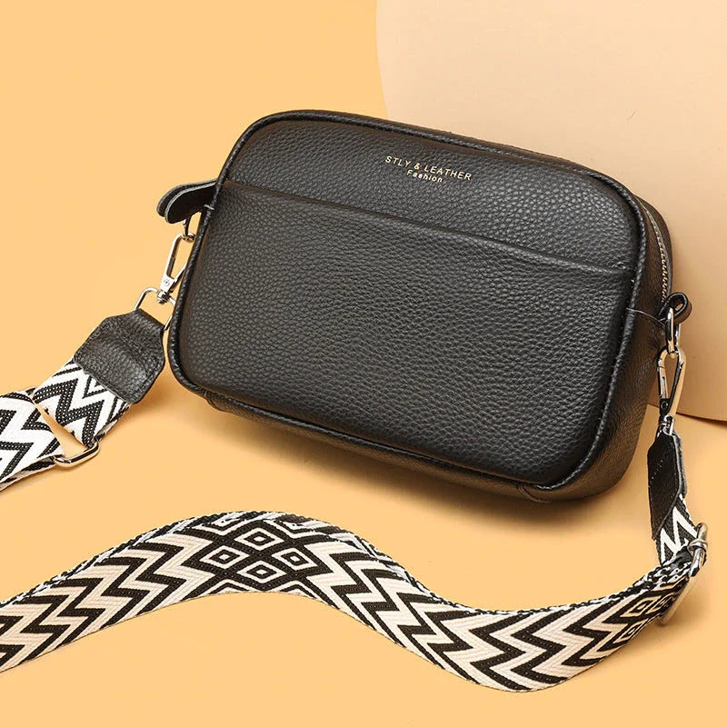 Stylish crossbody bag with rhombus embroidery, wide adjustable shoulder strap, and multiple interior pockets in various color options