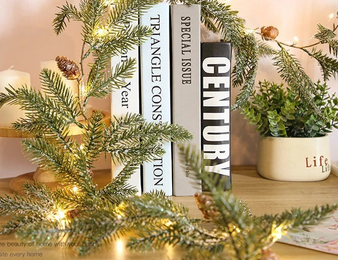 Decorative copper leaf string lights with rattan and pine needle accents, creating a cozy, festive atmosphere