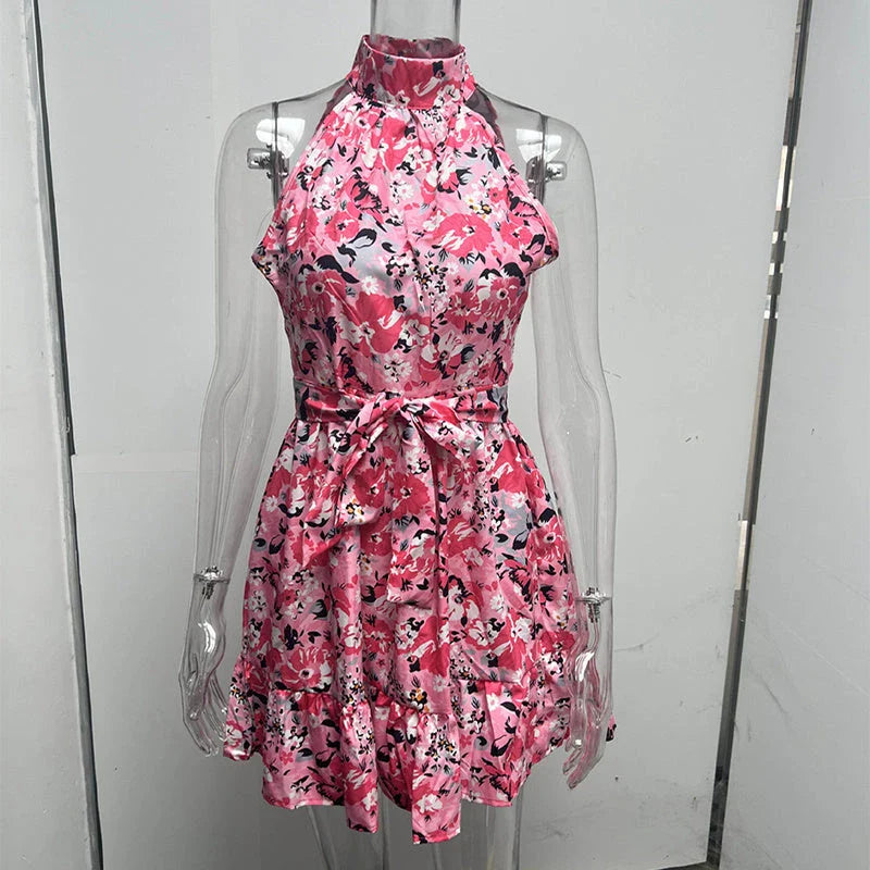 Chic floral halter dress in yellow and pink colors, featuring a flattering silhouette and ruffled details
