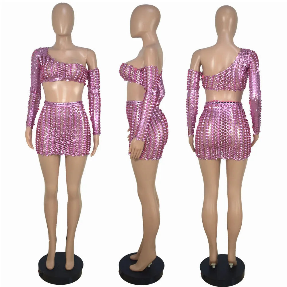 Women's black hollow-out two-piece set with sleeveless top and short skirt on a model.