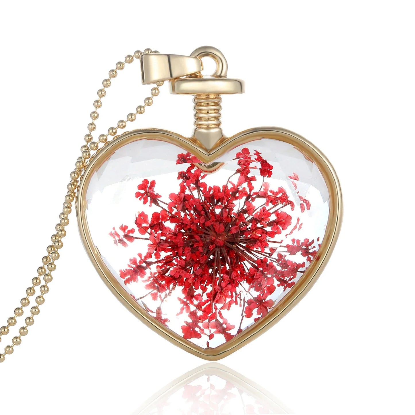 Elegant floral pendant necklace with a dried flower charm on a gold-tone chain